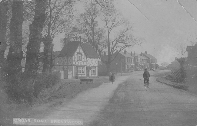 The real picture postcard shows Ongar Road, Road Brentwood and the 'ROBIN HOOD & LITTLE JOHN PUBLIC HOUSE'. It was postally used in 1914.