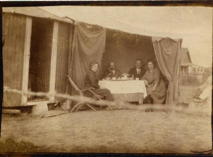 Henry and Hilda Goodhind are the couple on the right at their Hut on Canvey Island