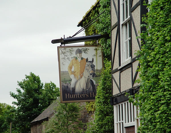 Hunters Hall Inn sign, Kingscote, Tetbury - in June 2013