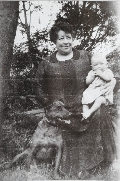 Elizabeth Pocock, proprietor and resident landlady of the Star Hotel, High Street, Barnet, seen holding newly arrived Harry, 1926 in the rear garden with 'Old Jack' - a family friend.