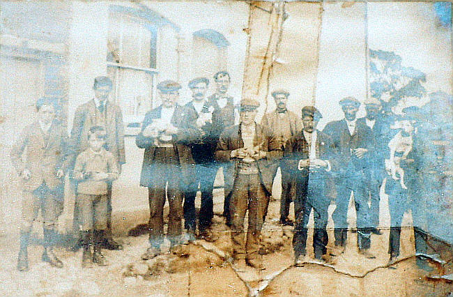 A close up of the yard to the left of the Hoops which shows a group of agricultural workers. 