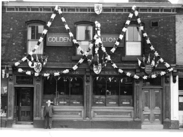 William Goodliffe outside the Golden Lion, 532 Oldham Road, Manchester, Lancashire in 1953 at th Coronation