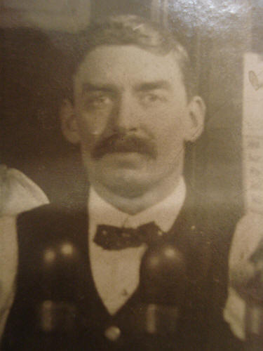 Ernest Easty behind the bar at his pub. He is probably around age 35, the time of the 1901 census when he was running the Ship Afloat.